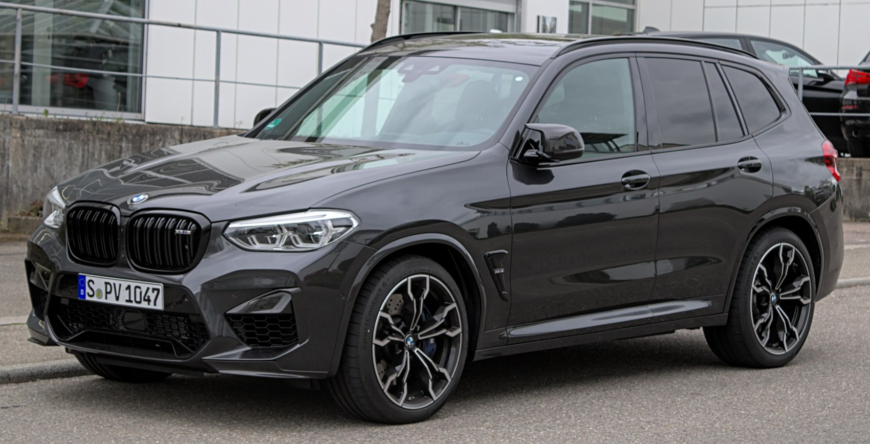 Black SUV with sharp headlights, iconic grille, and sporty alloy wheels