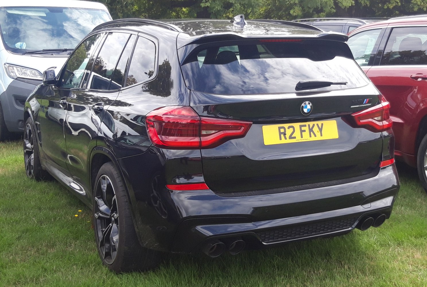 Rear view of sporty SUV with quad exhausts and aerodynamic spoiler