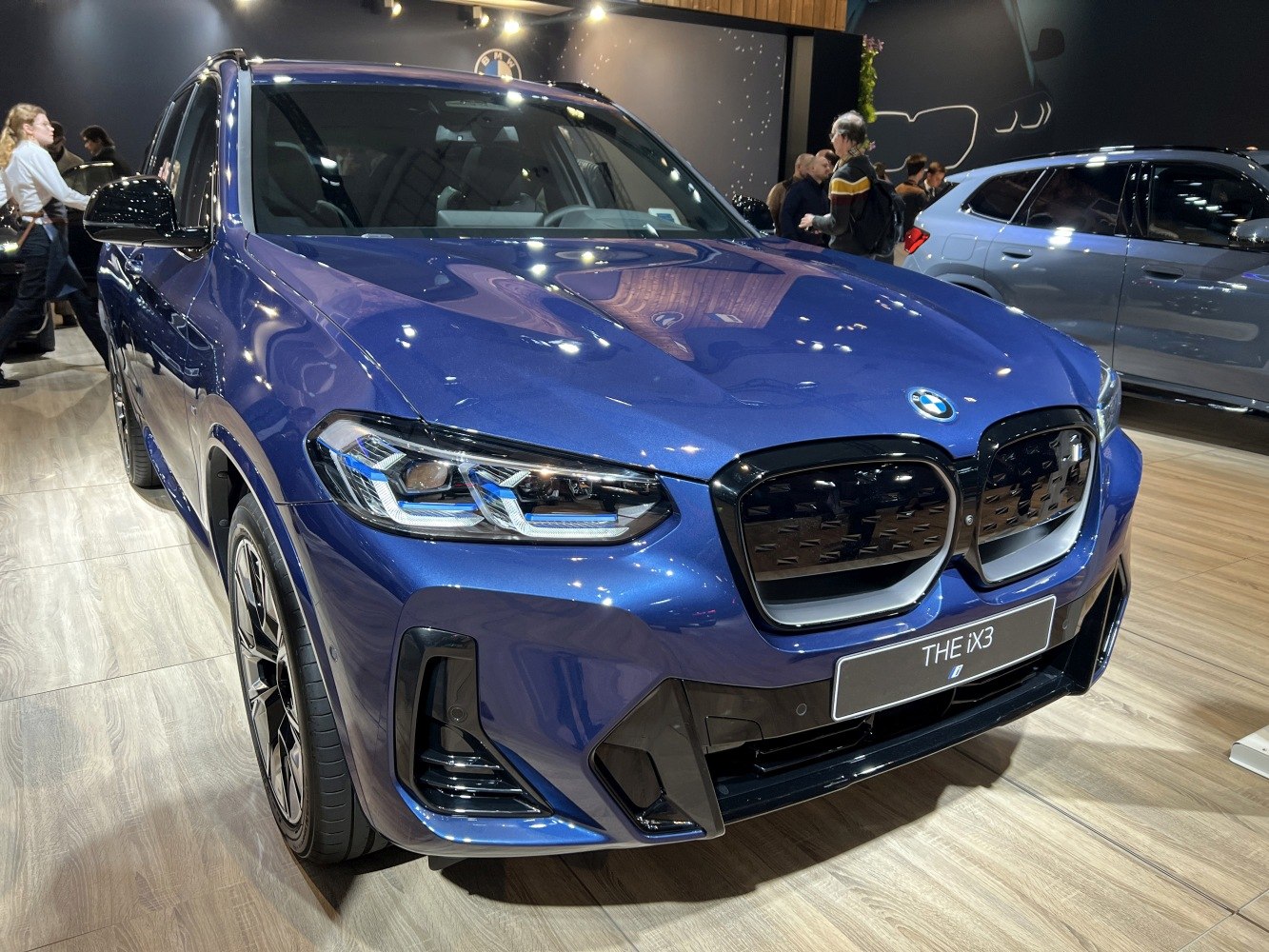 Front grille and adaptive LED headlights of electric SUV.