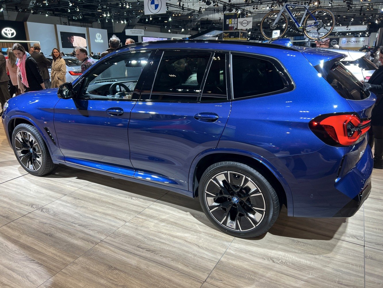 Side profile of blue electric SUV with alloy wheels and tinted windows