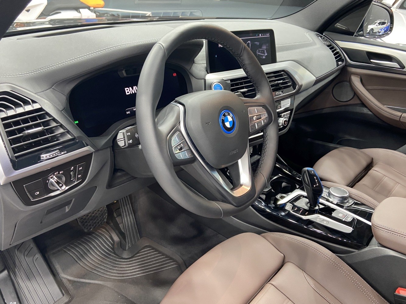 Digital dashboard and multifunction steering wheel in a modern car interior.