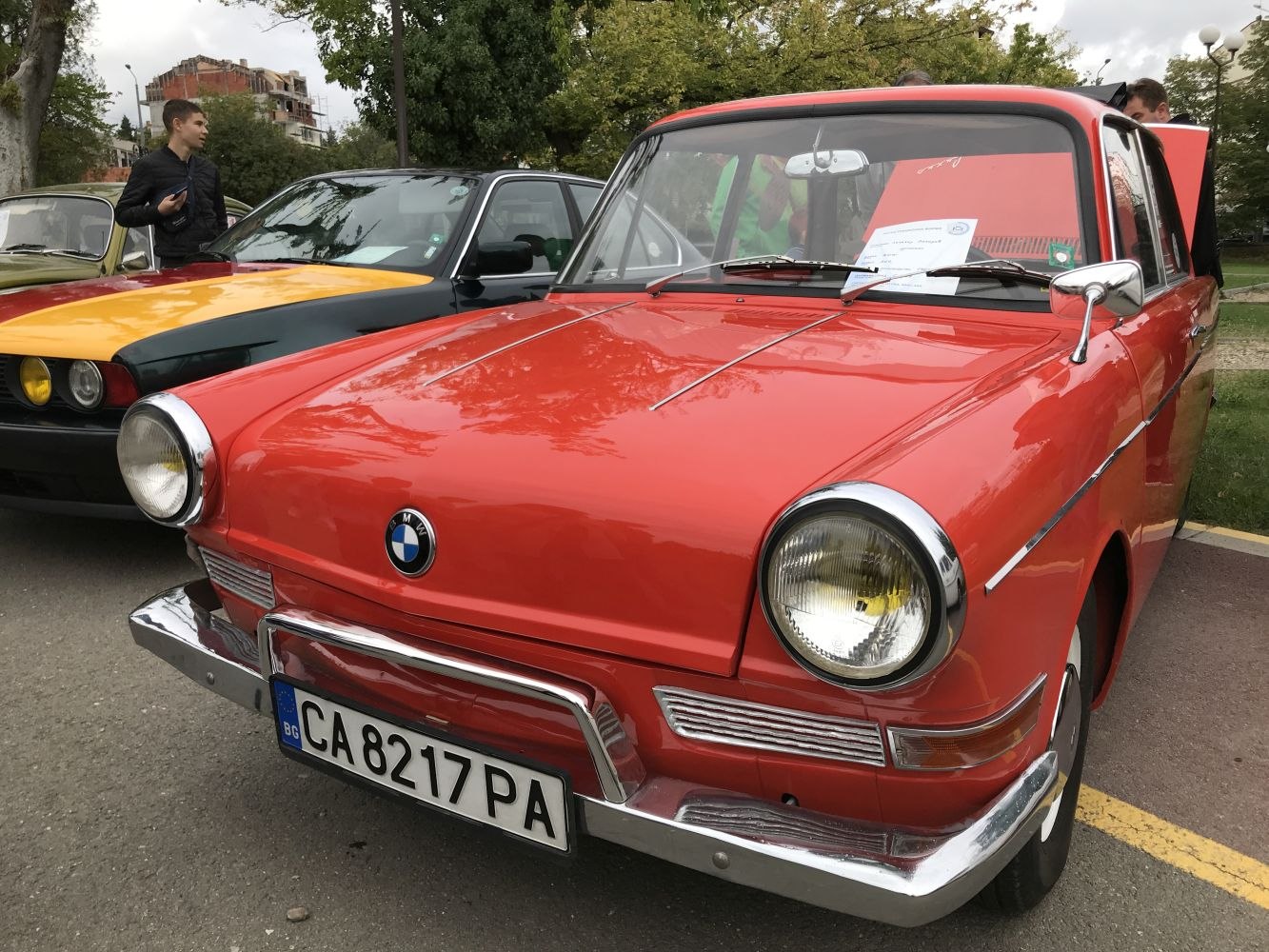 Front view of a vintage car with round headlights and chrome bumper