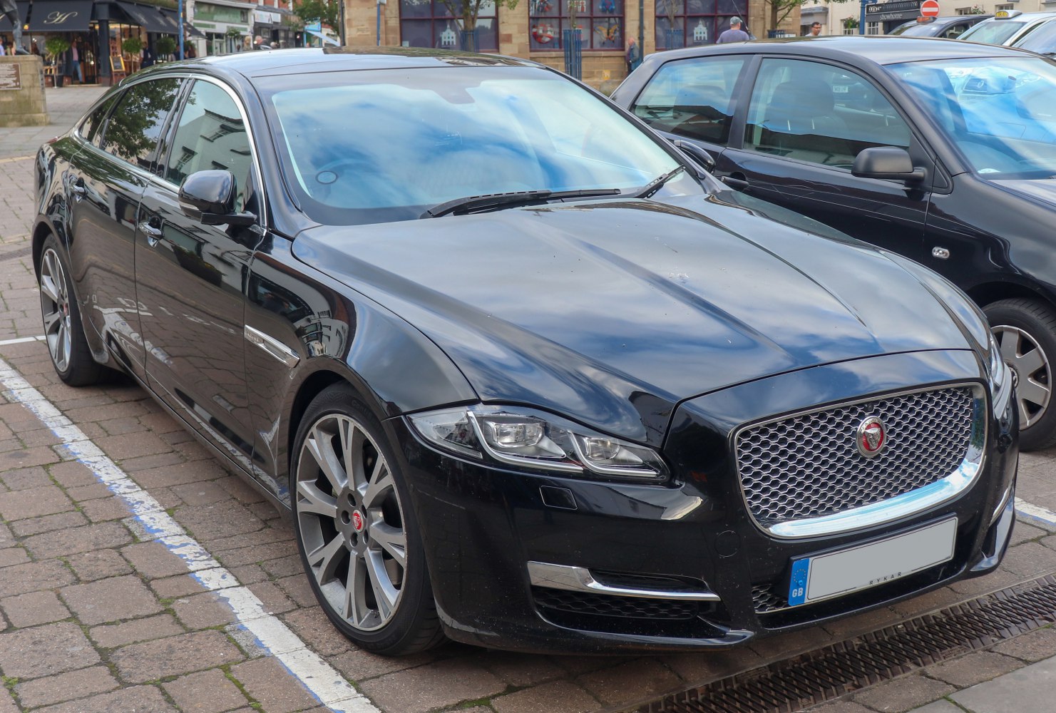 Luxury sedan front side with distinct grille and sharp headlights