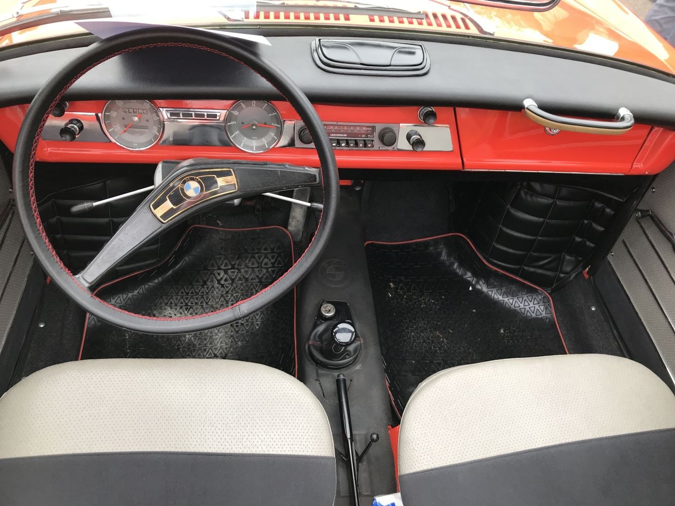 Vintage dashboard and steering wheel with speedometer, tachometer, and classic controls