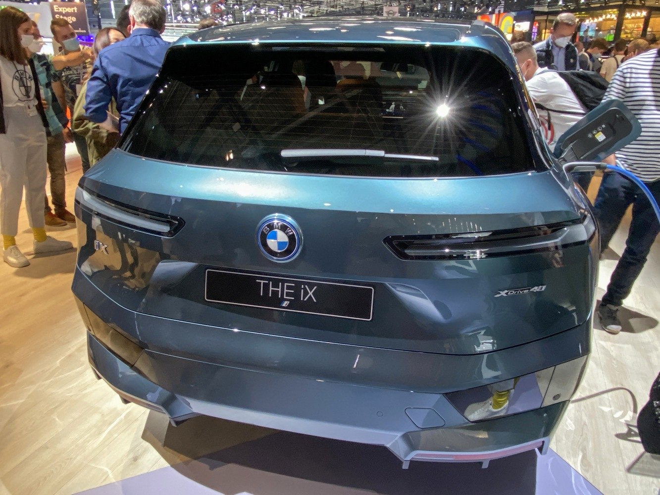 Rear view with sleek taillights and visible charging port connection