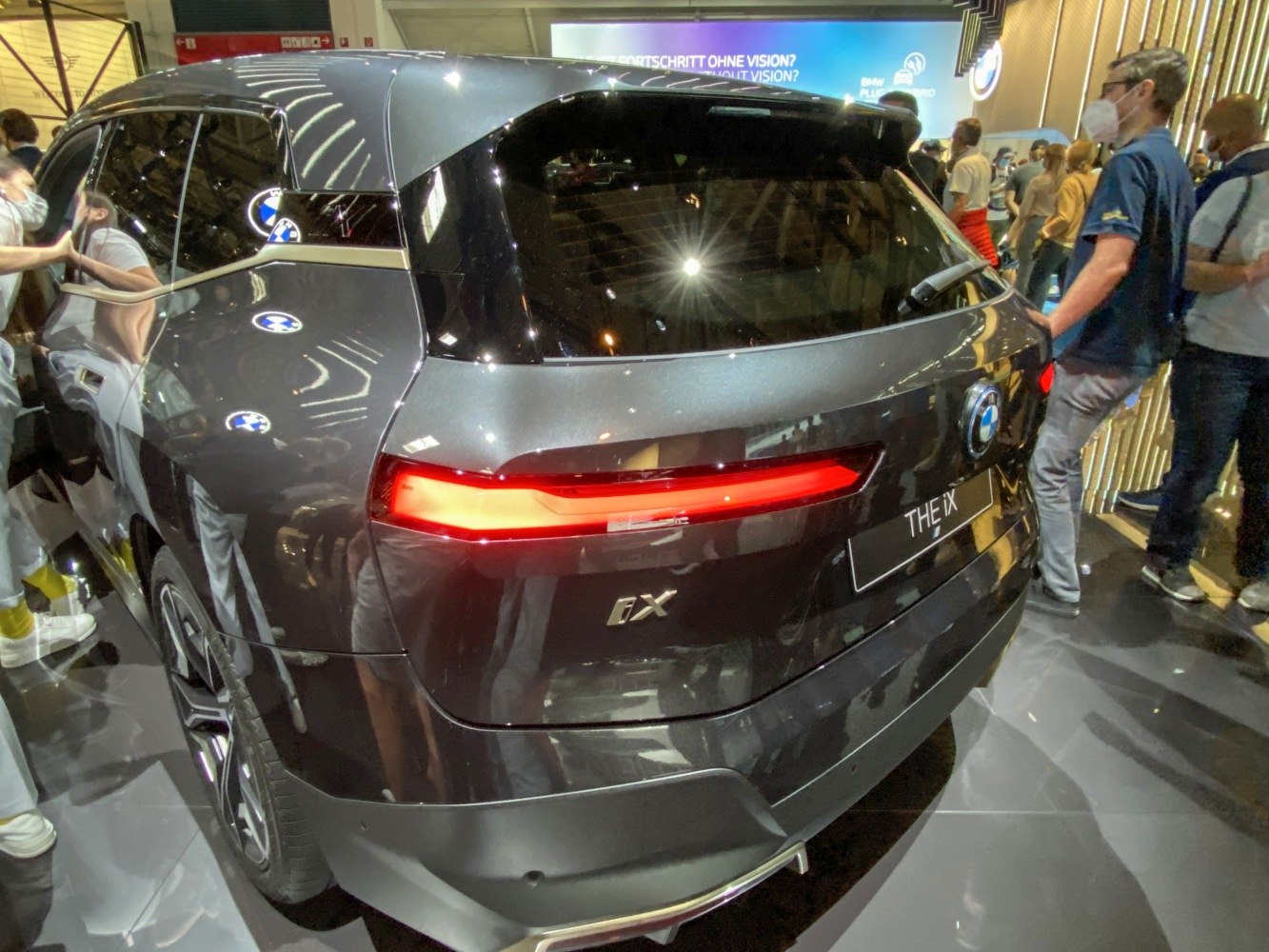 Rear view of BMW iX with illuminated LED tail lights