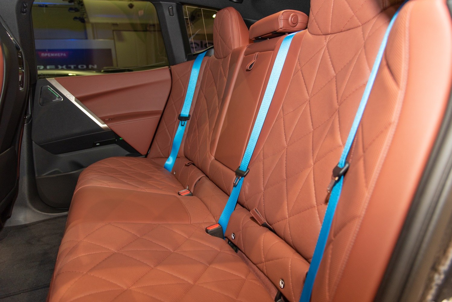 Premium brown quilted rear seats with contrasting blue seatbelts