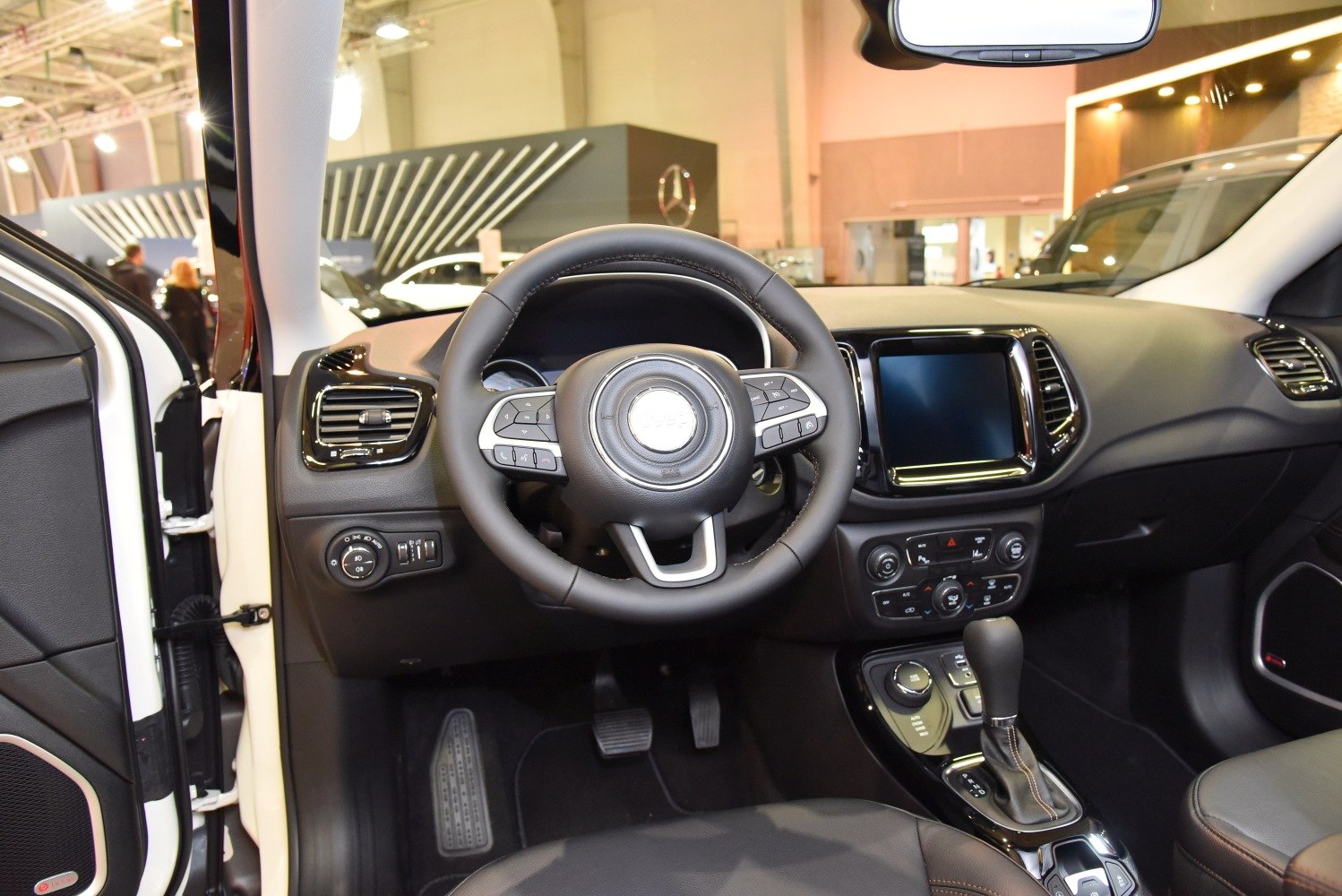 Steering wheel, dashboard and central control console of modern SUV interior.