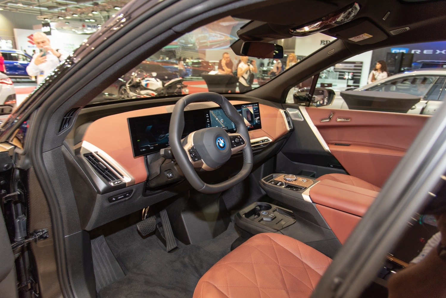 Modern digital dashboard and leather seating inside vehicle