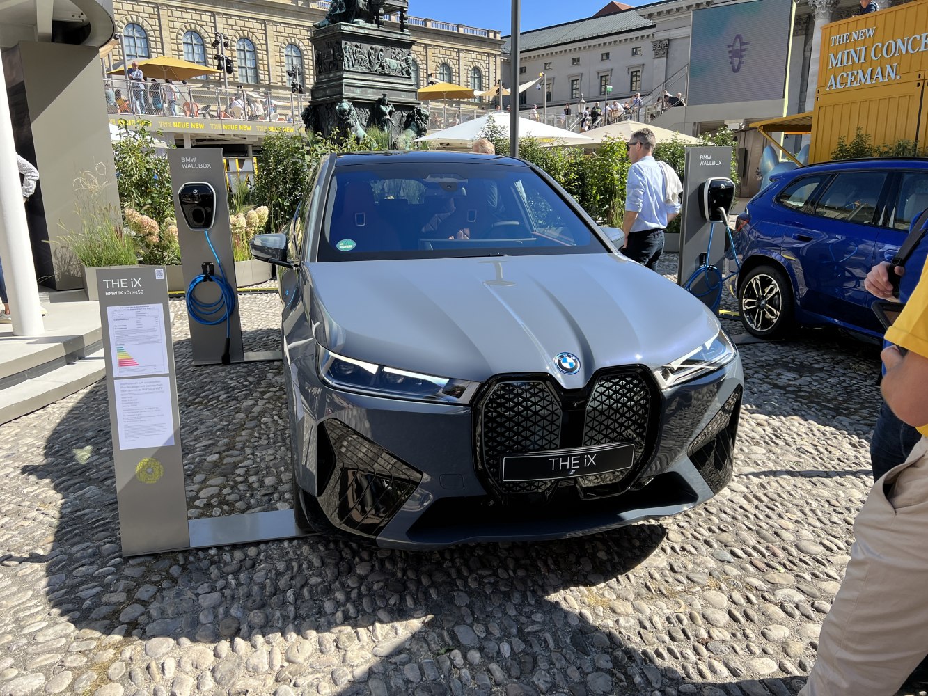 Front view of silver electric SUV at BMW charging station