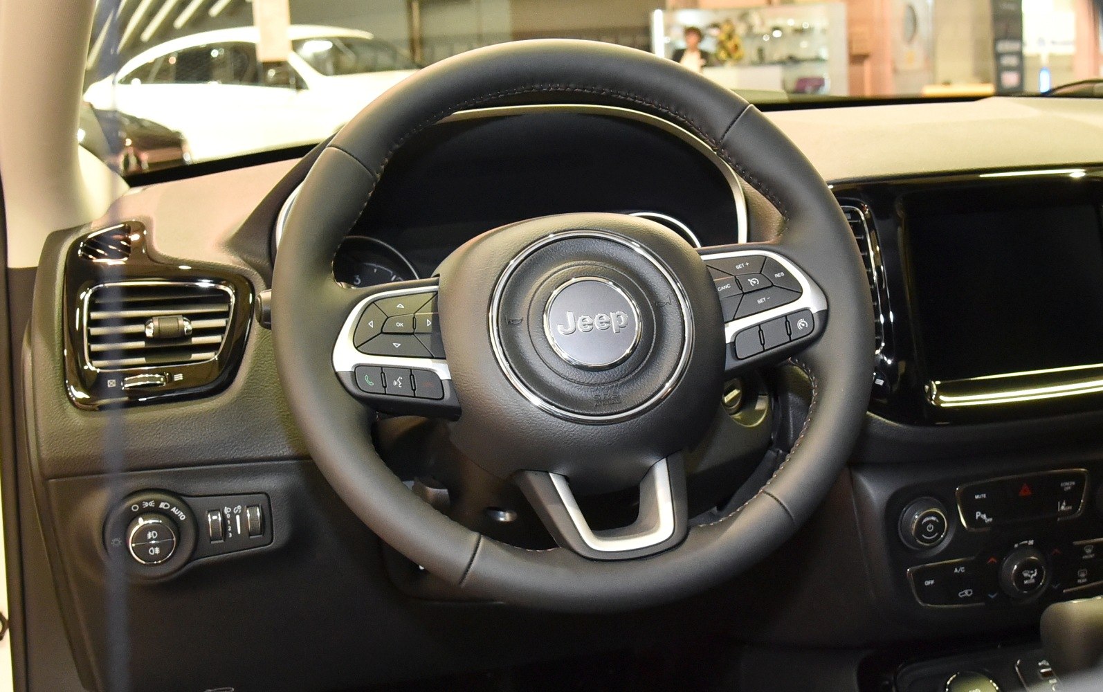 Steering wheel and dashboard controls close-up with integrated buttons