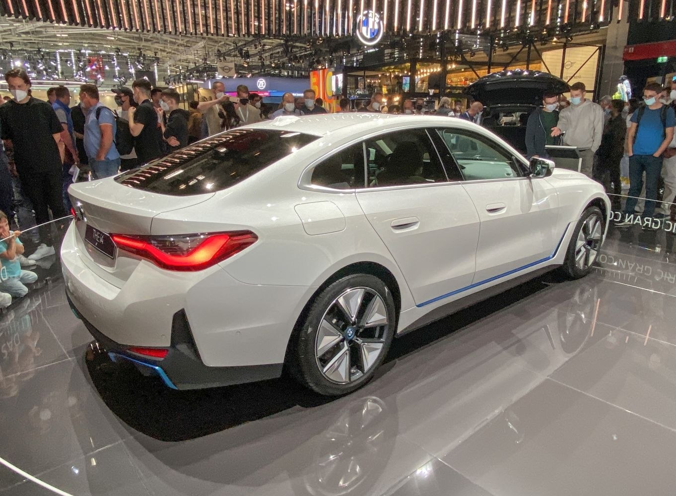 Rear and side view of a white electric sedan with LED taillights and alloy wheels.