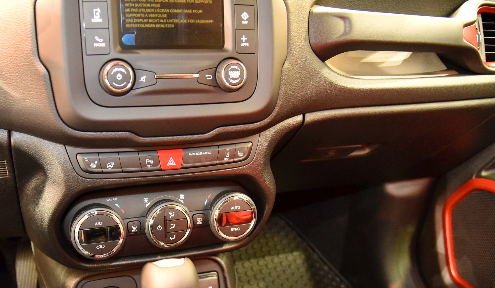 Climate control dials and media console buttons in vehicle interior