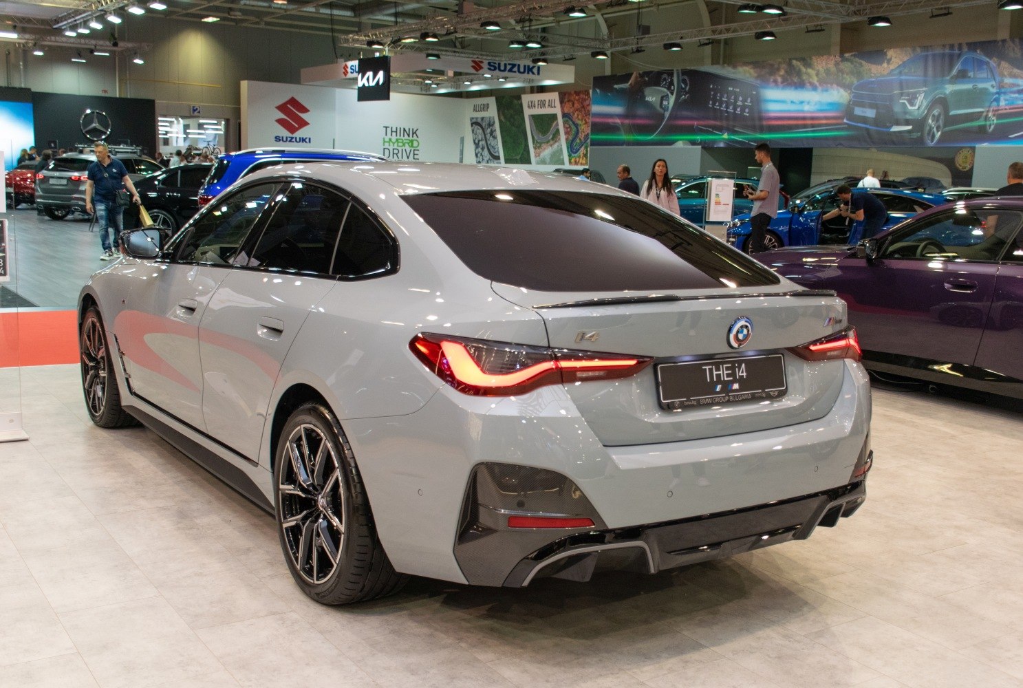 Rear-side view of a sleek electric sedan with modern taillights and sporty rear design