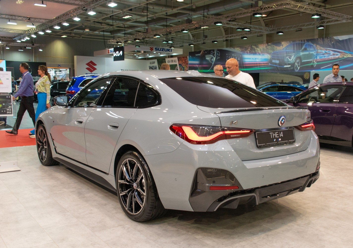 Rear-side view of a sleek electric sedan with LED taillights and sporty wheels
