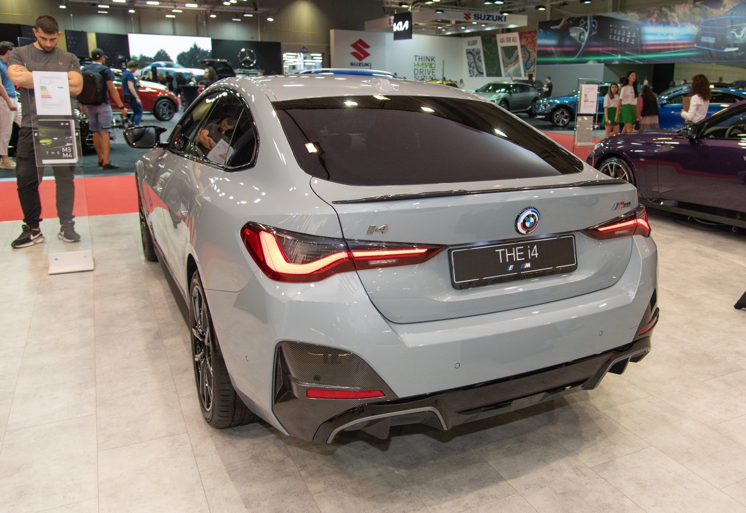 Rear view of electric sedan with distinctive tail lights and sporty design.
