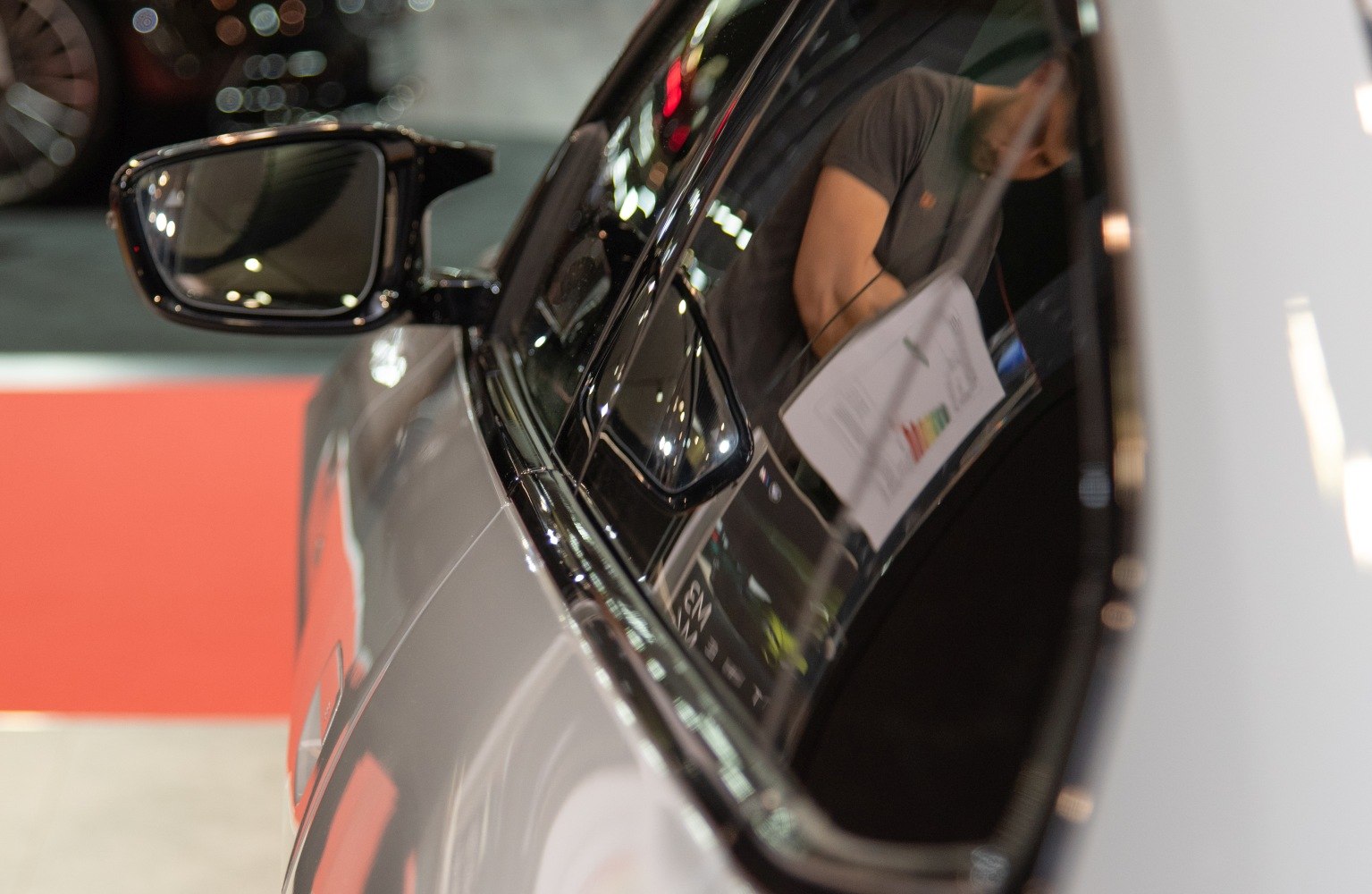 Close-up view of side mirror and reflective side window surface