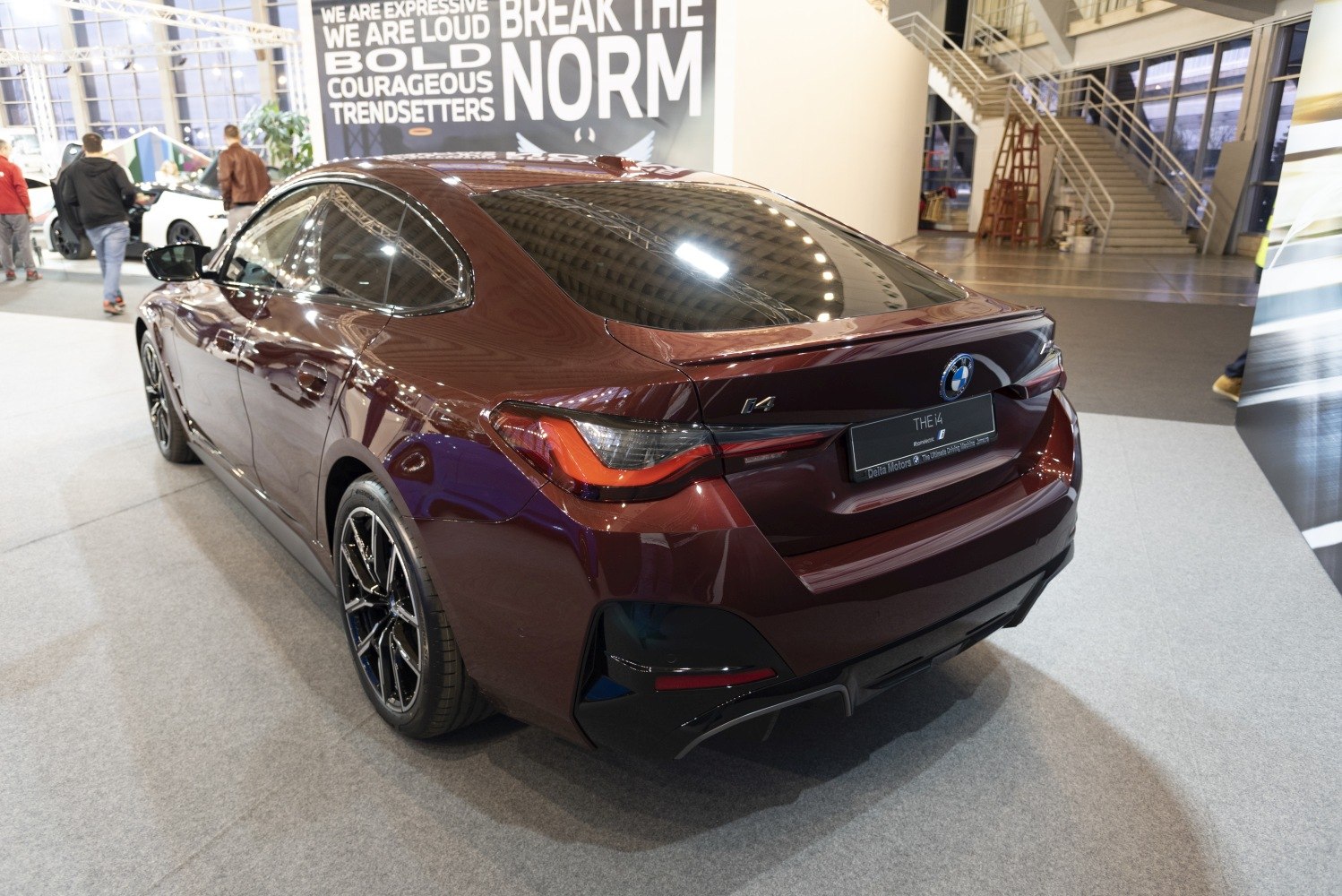 Rear side view of an electric gran coupe with sleek taillights and alloy wheels