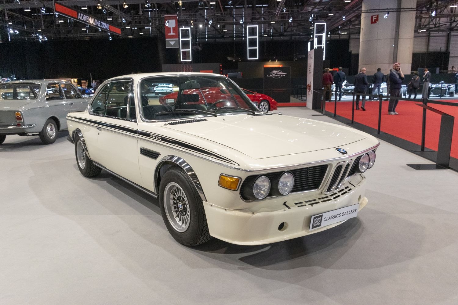 Quad round headlights, wide fenders, aerodynamic bumper, classic coupe