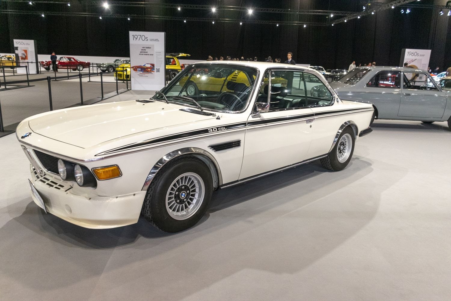 White vintage 1970s coupe with sporty rims and classic front grille