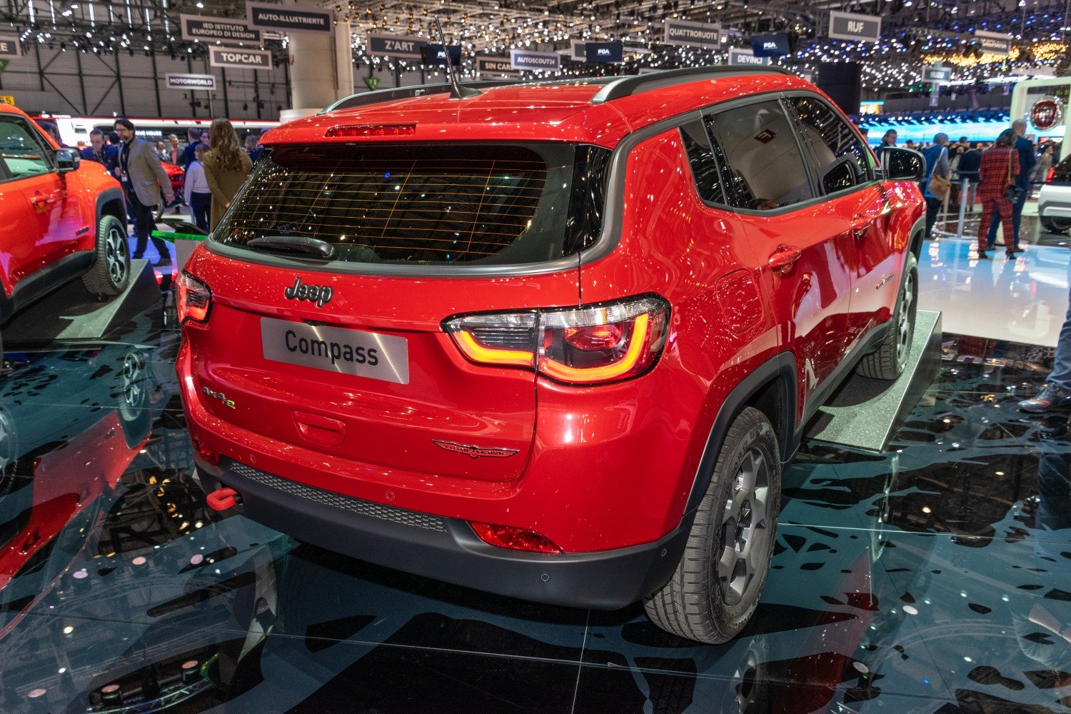 Rear of red compact SUV with LED tail lights and roof rails