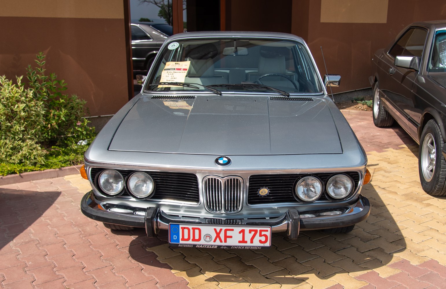 Front view with dual round headlights and kidney grille.