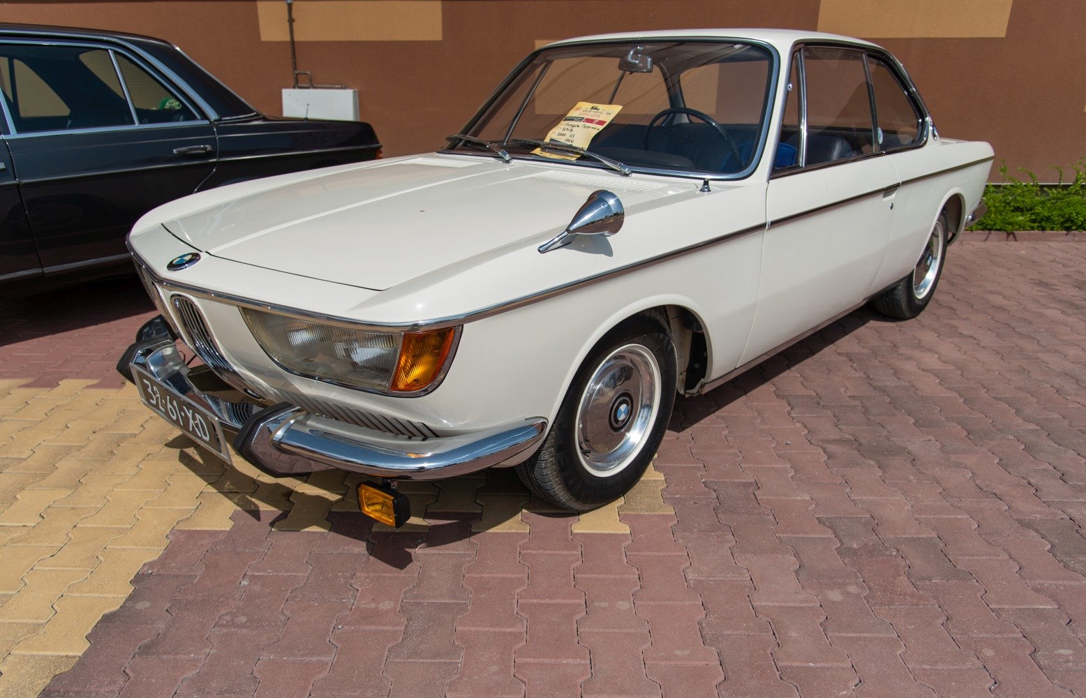 Vintage coupe with chrome details and side mirror