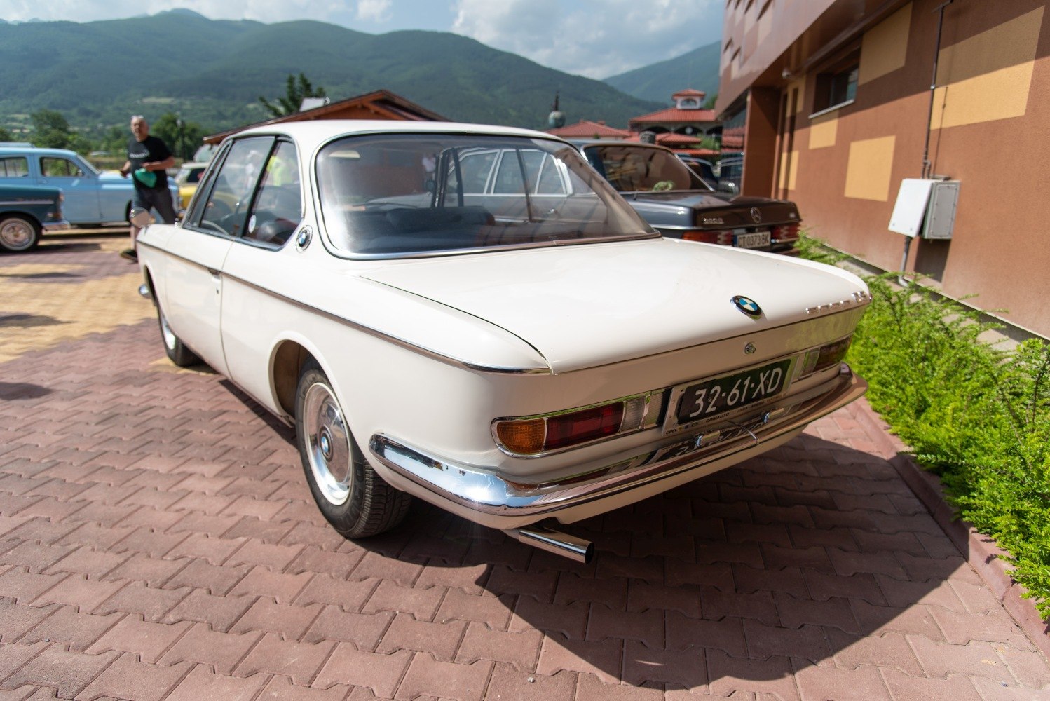 Rear view with classic taillights and chrome bumper of vintage coupe