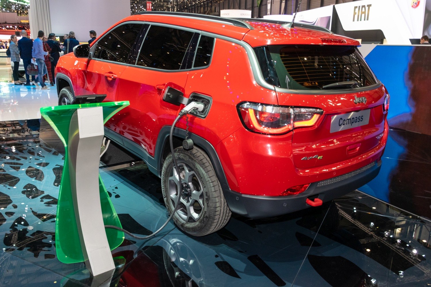 Red SUV with electric charging port connected