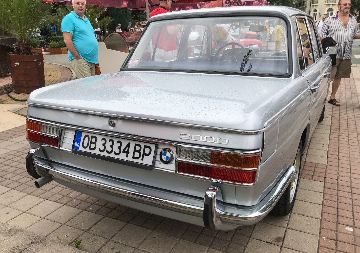 Rear view of classic vintage sedan with chrome bumper and taillights.