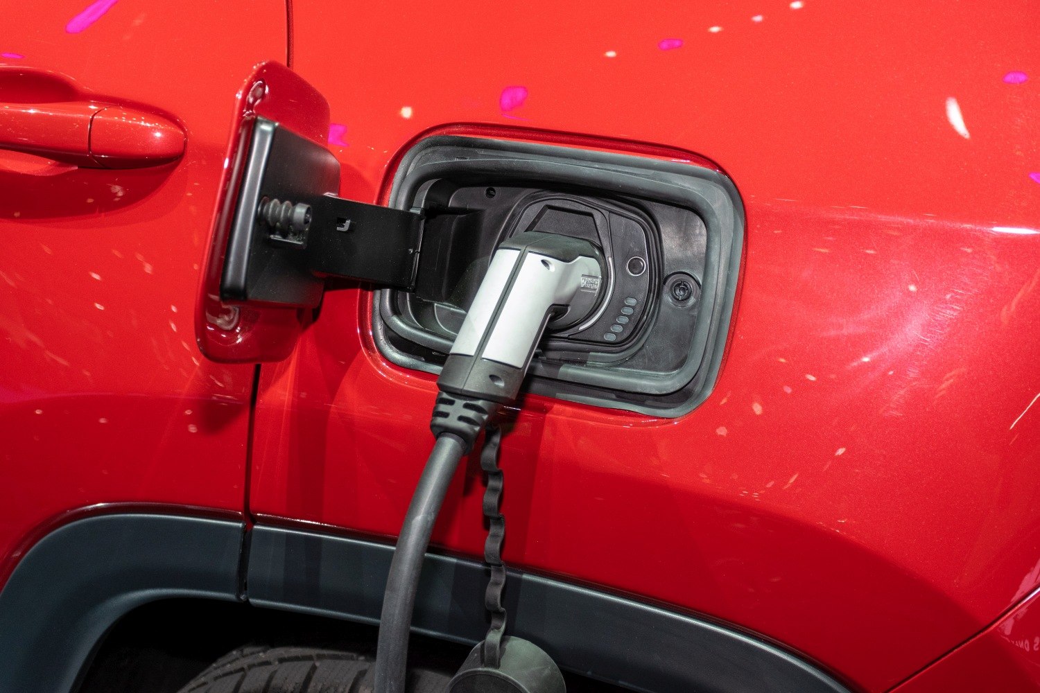 Electric vehicle charging port with connector plugged in