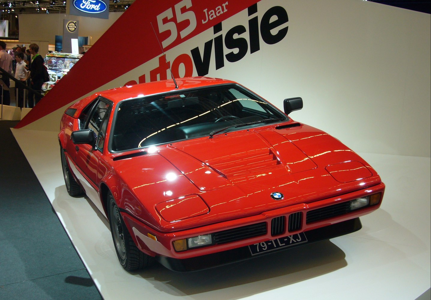 Red sports coupe with pop-up headlights and hood air vents