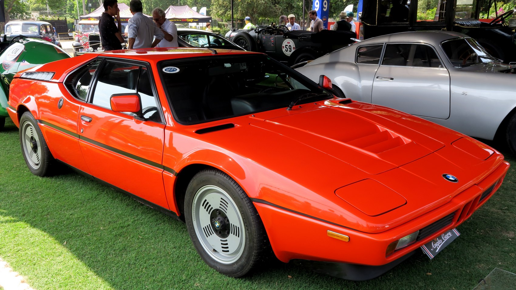 Red angular sports coupe with mid-engine layout and iconic wheels
