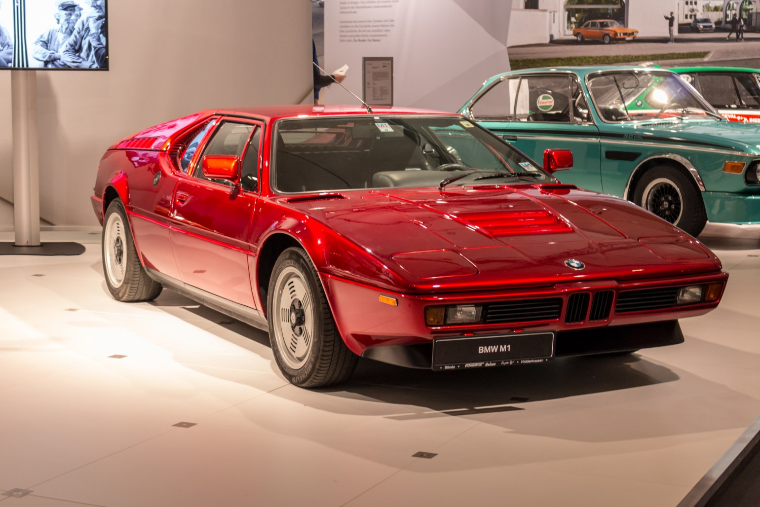 Red mid-engine classic sports coupe with sleek retro design.