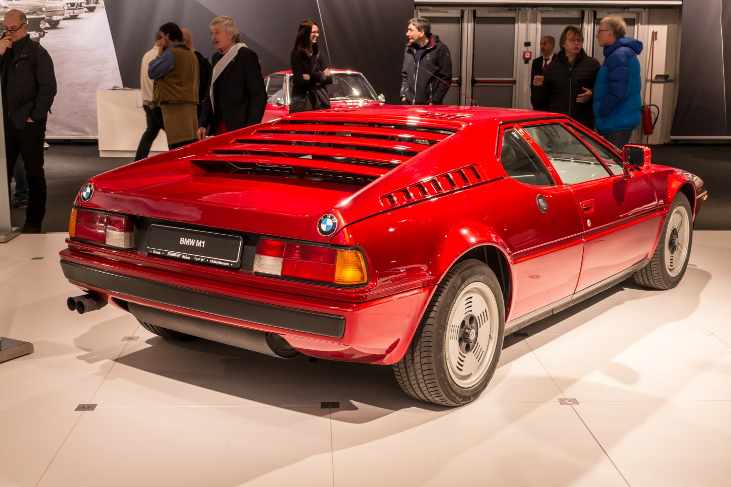 Red sports coupe rear with angular louvers and unique wheel design