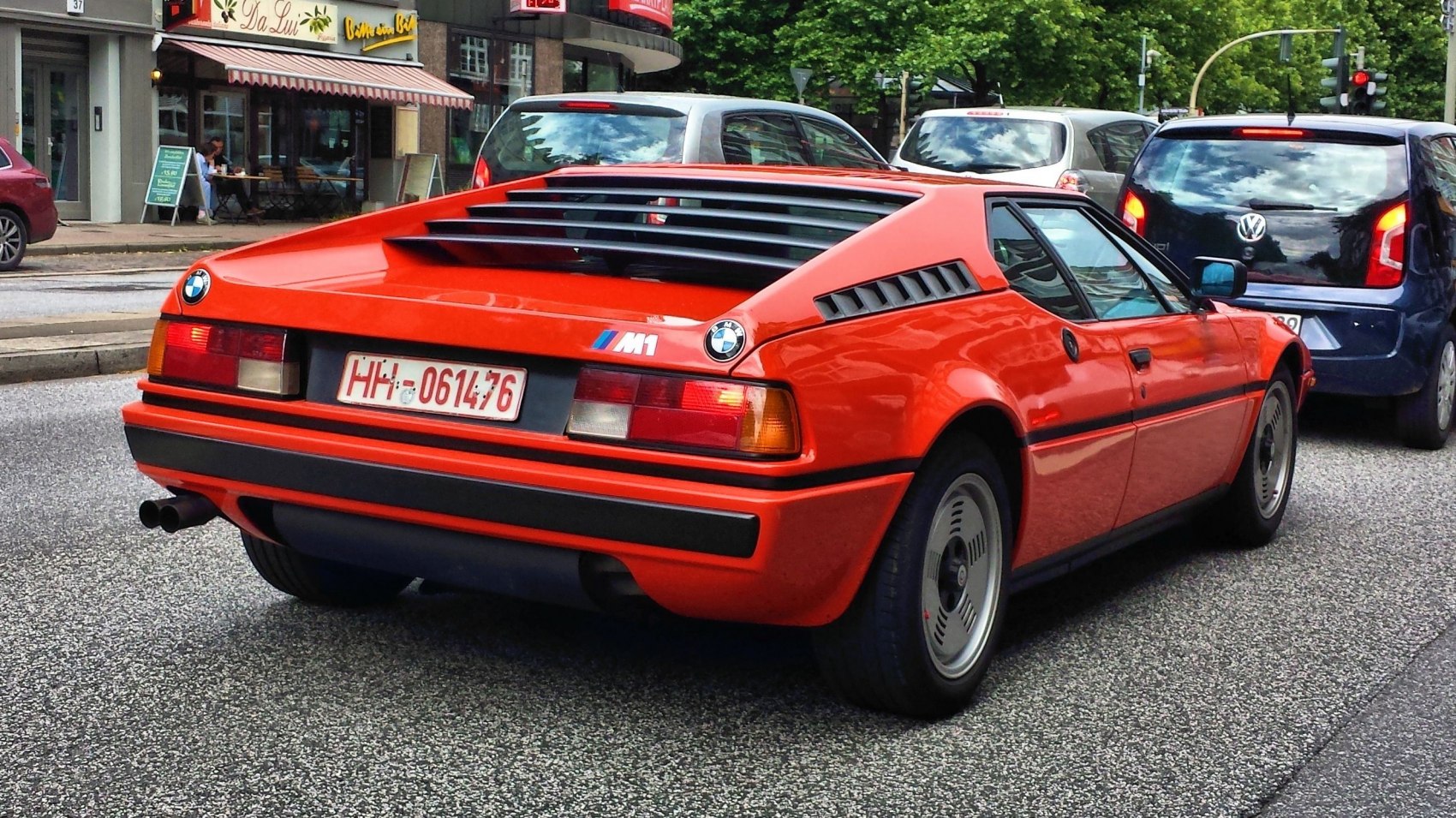 Rear view of red sports car with ventilation louvers and classic taillights
