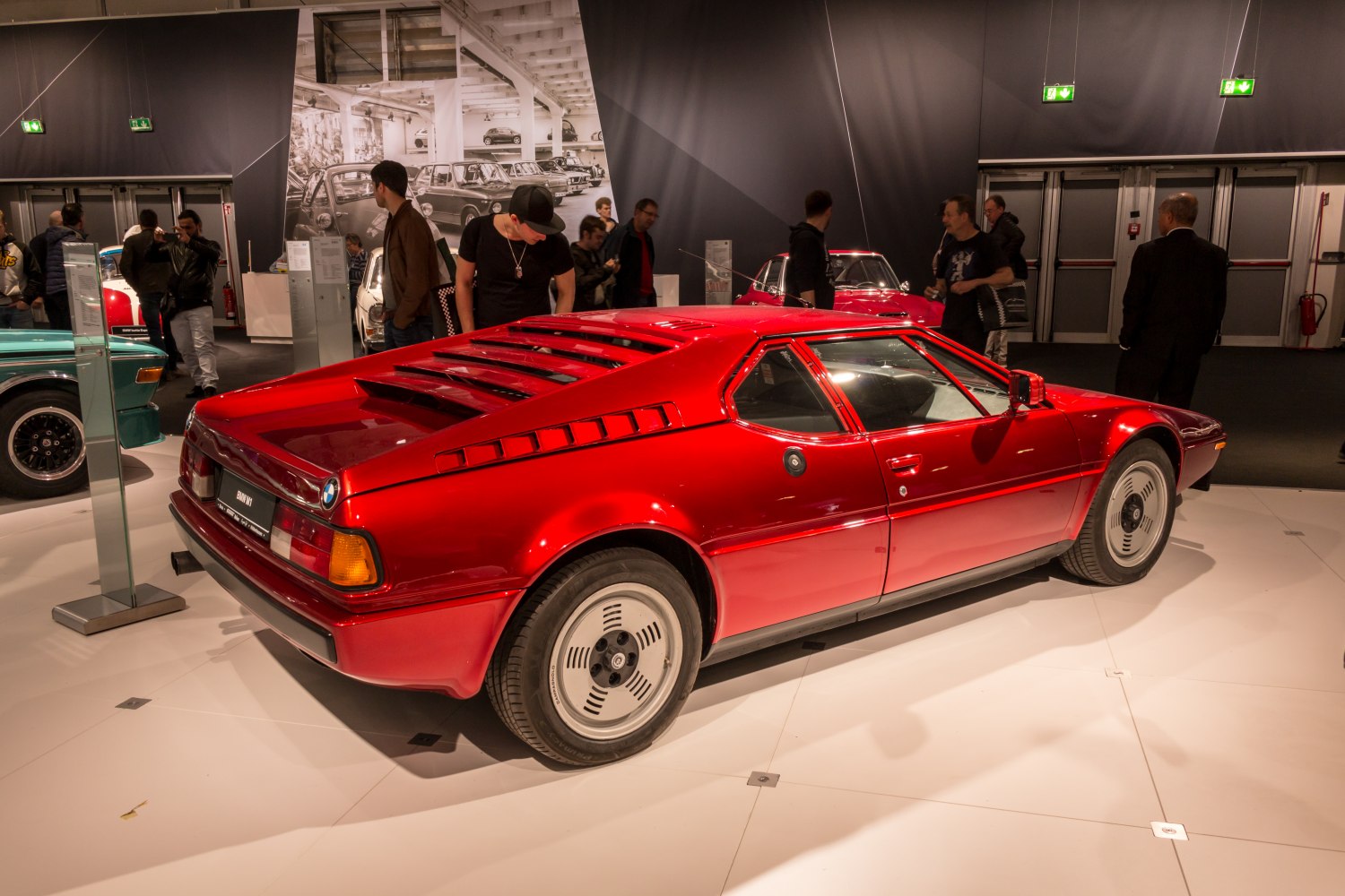 Red vintage sports coupe with rear window louvers and unique aerodynamic wheels
