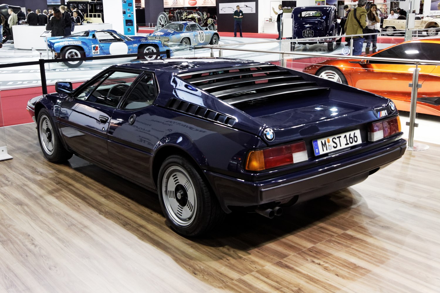 Rear side view of vintage sports car with rear window louvers and angular design