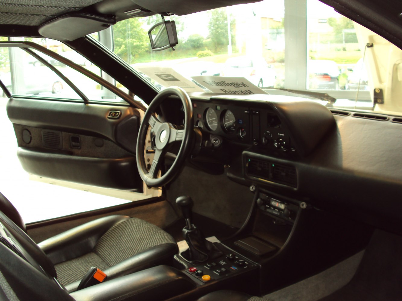 Classic vintage interior with steering wheel, dashboard, and center console