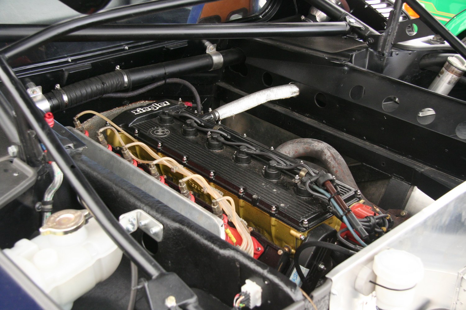 Close-up of a high-performance inline-6 engine in a race car engine bay