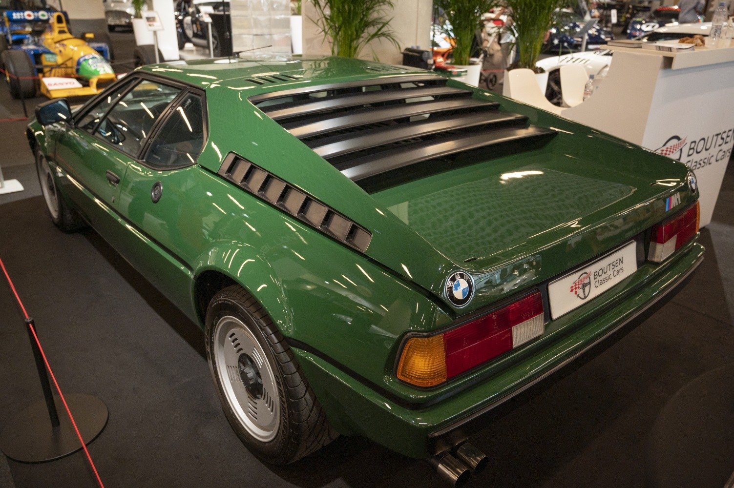 Rear window louvers and side air vents on a classic green sports coupe