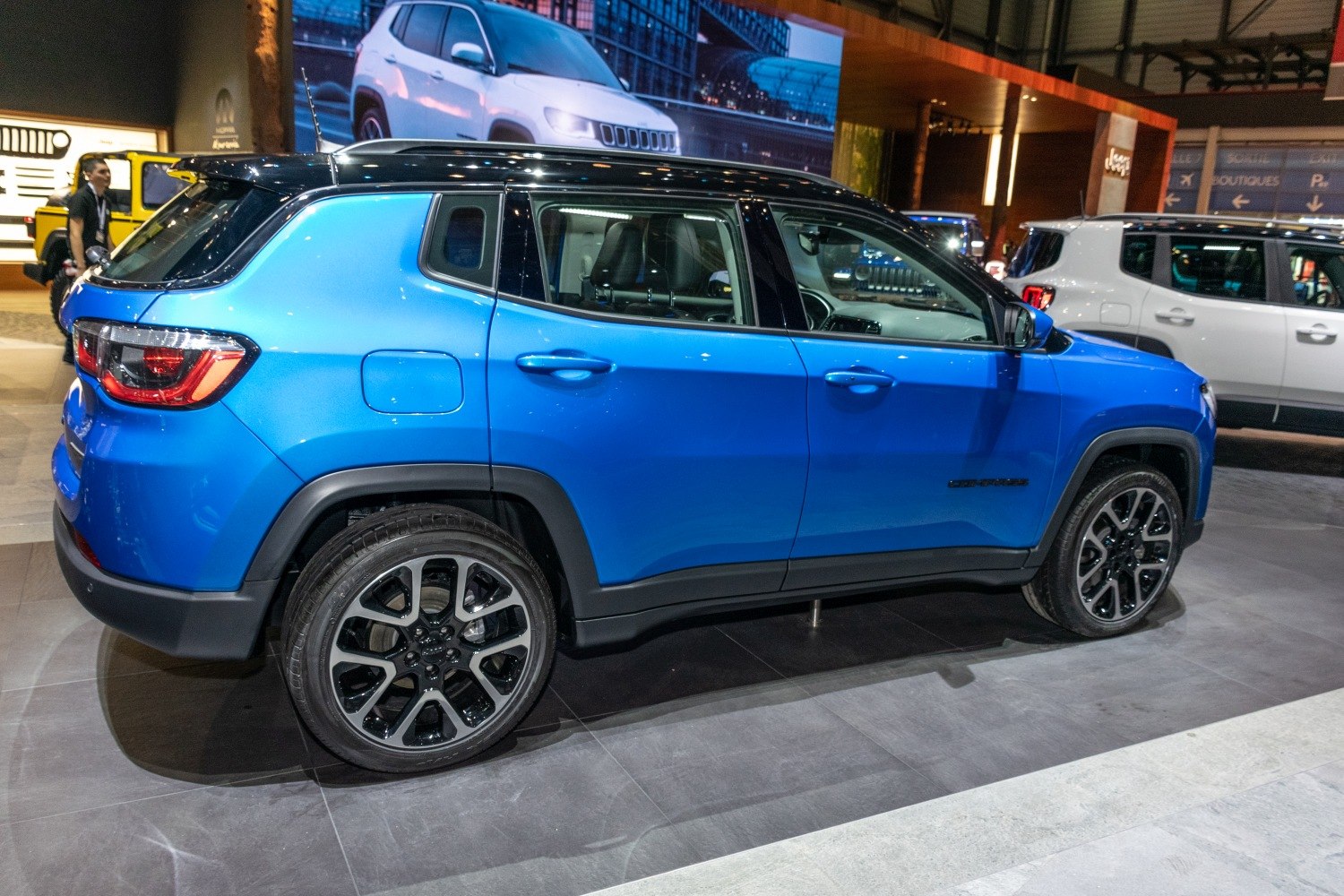 Side profile of blue SUV with black roof and alloy wheels