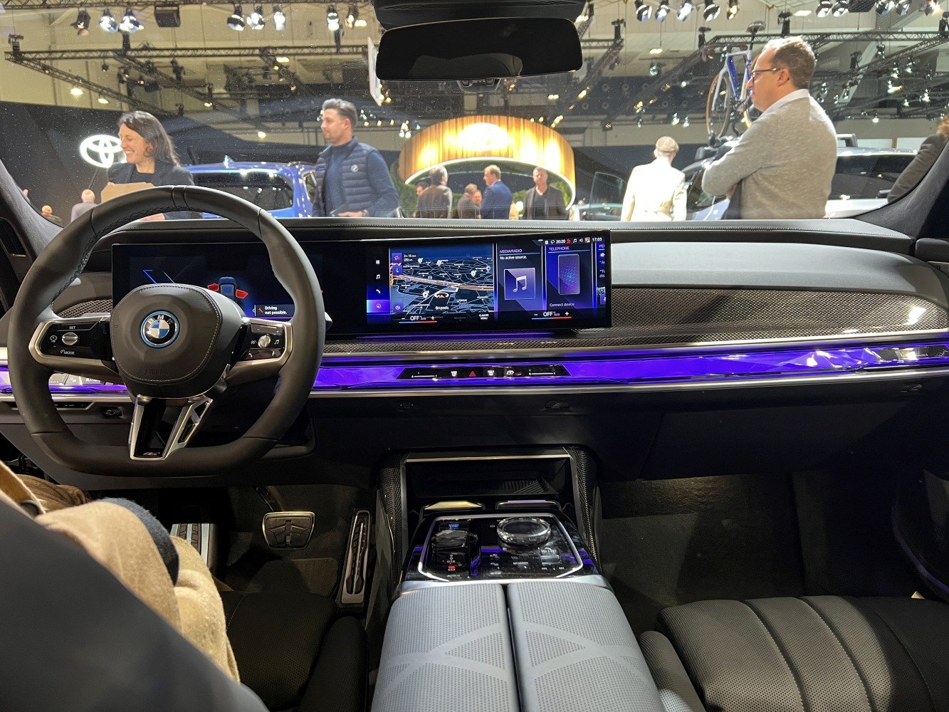 Digital dashboard and ambient purple lighting in luxury car interior