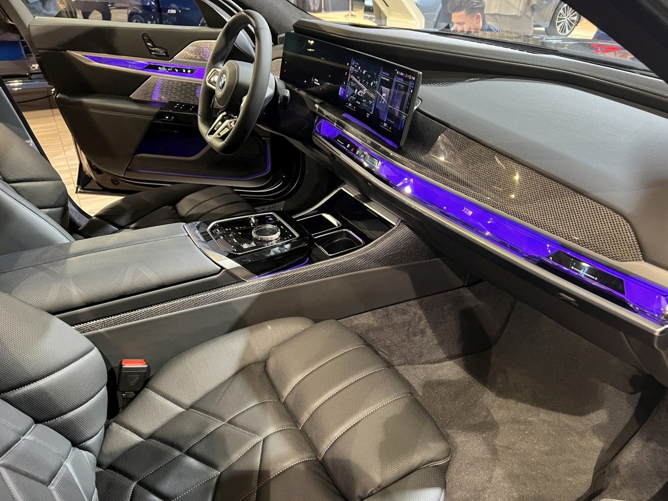 Luxury car interior with digital display and purple ambient lighting