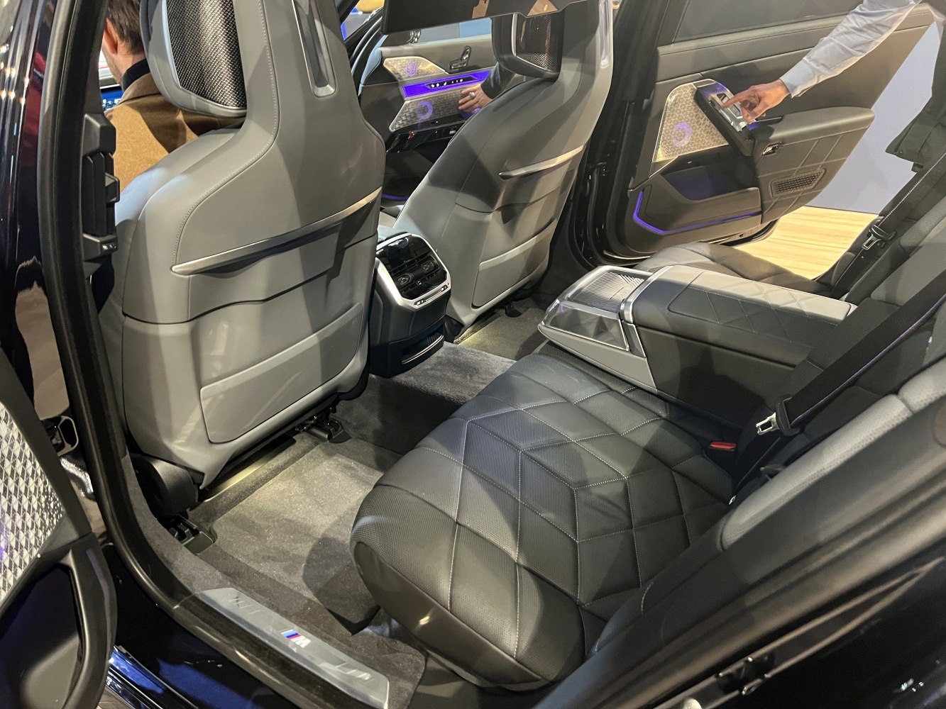Luxury rear seating with quilted black leather and ambient lighting