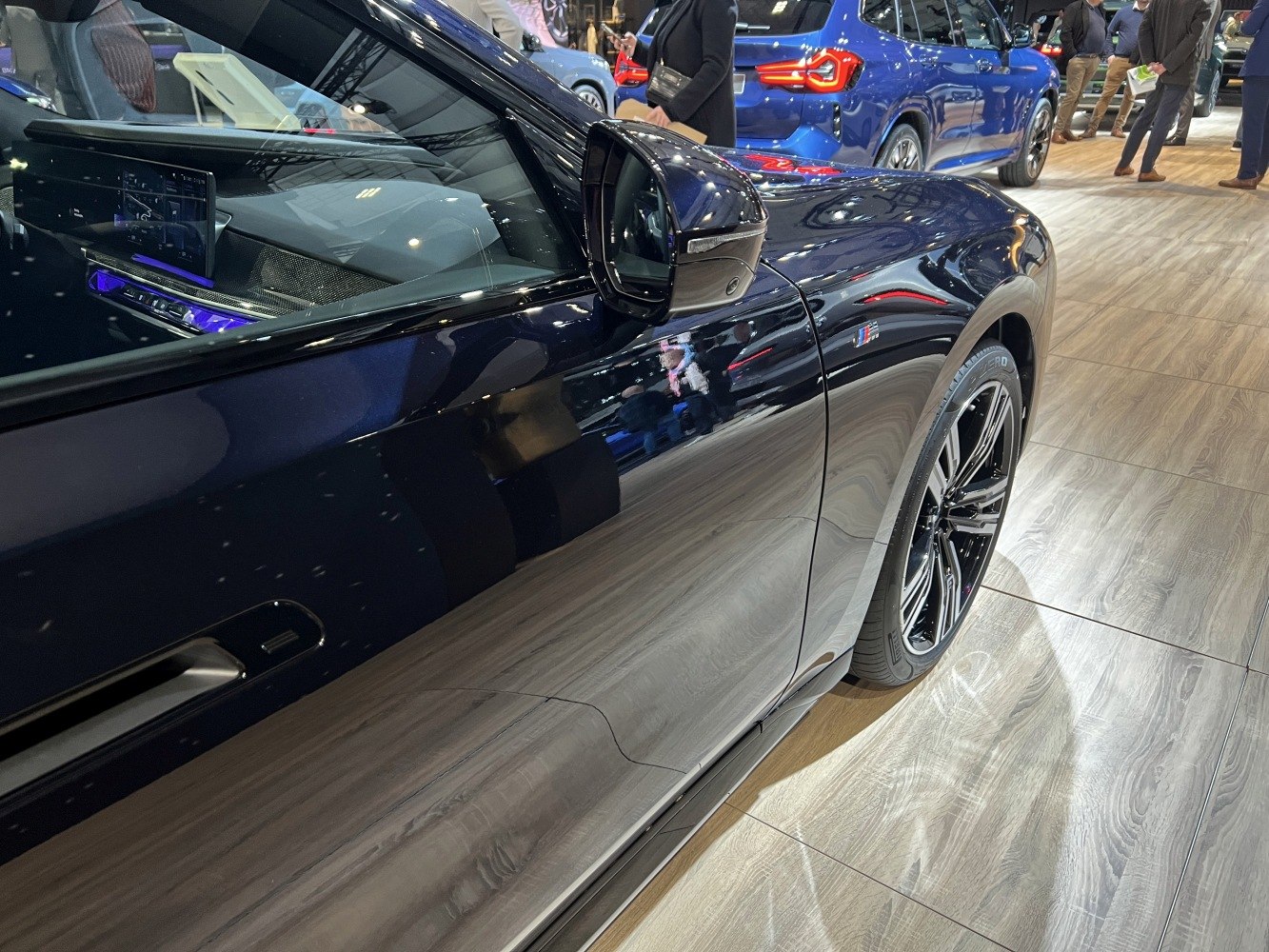 Close-up of side door, mirror, and wheel design with M badge