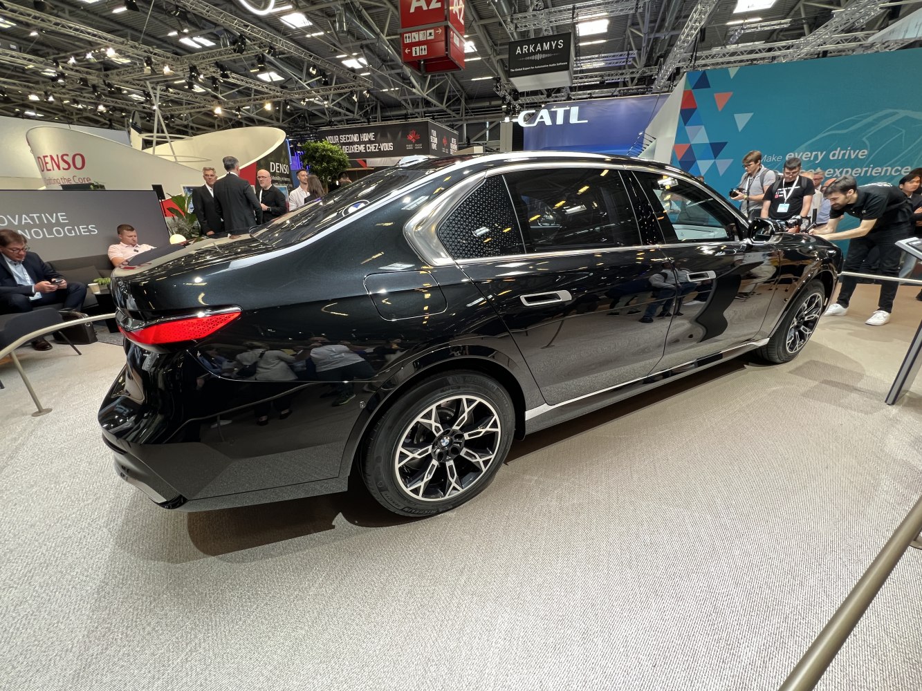 Black luxury sedan with smooth rear and multi-spoke alloy wheels