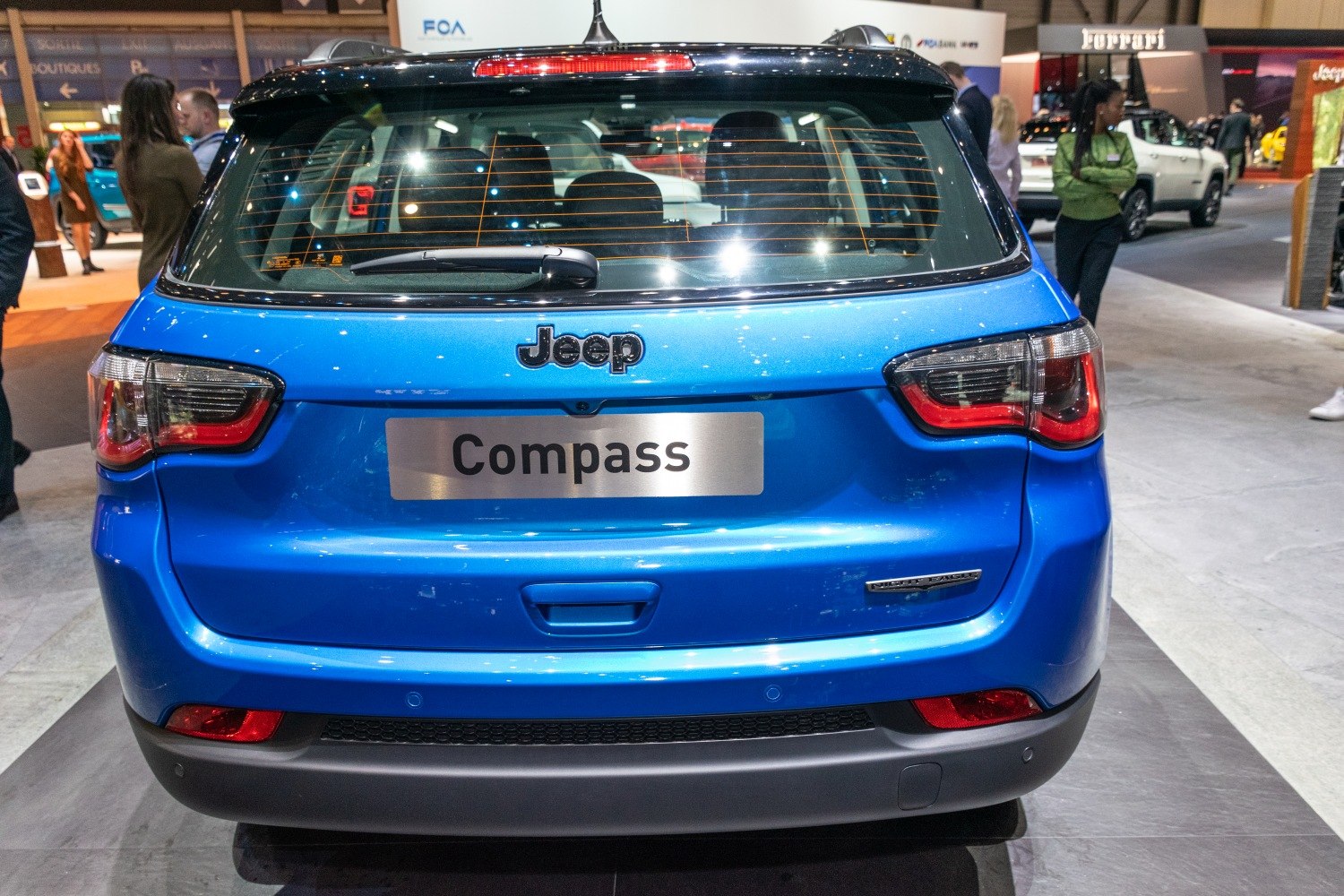 Rear view with distinct taillights and hatchback rear window with wiper
