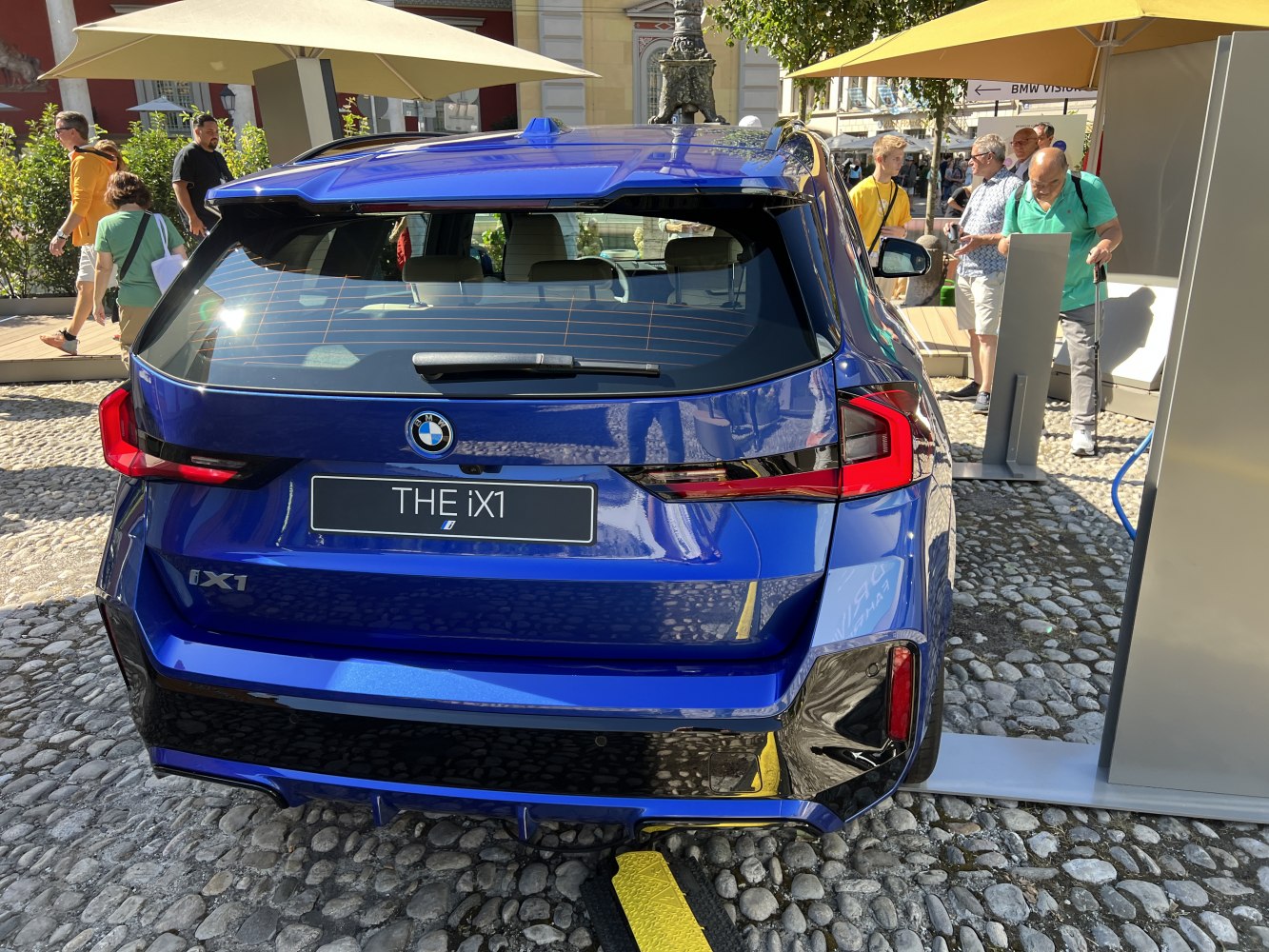 Rear view of electric SUV with taillights and charging port