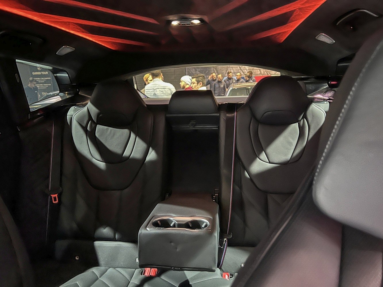 Rear leather seats with center armrest and cup holders